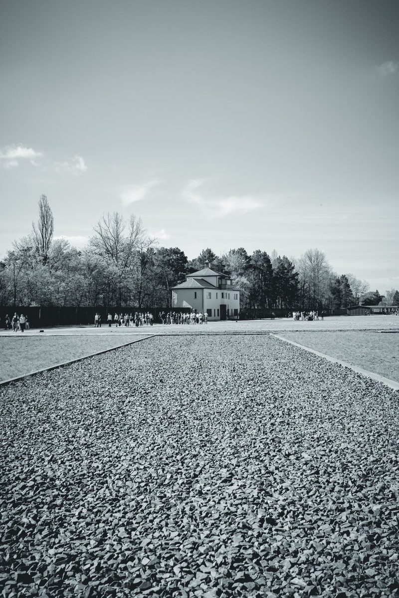 Gravel marks the site of a vanished barrack. In the distance, Tower A and the visitors.