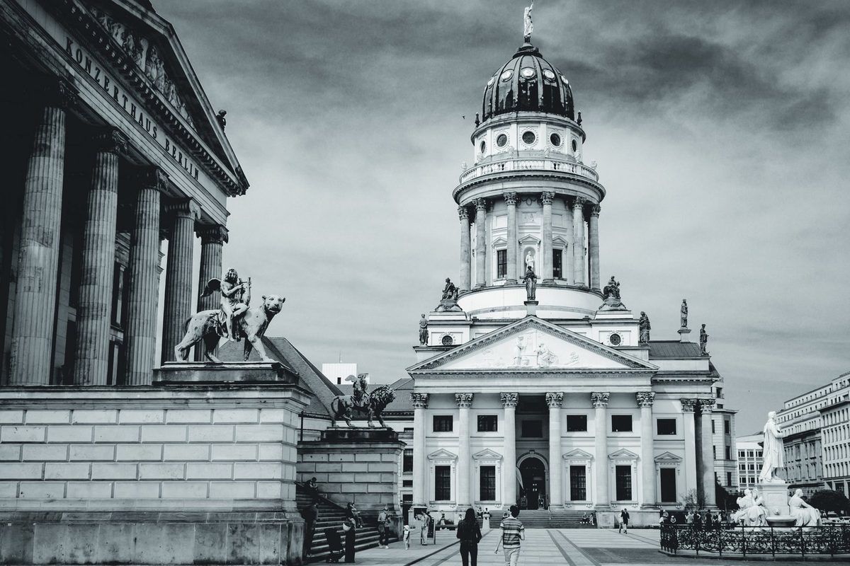 The columns of the Konzerthaus Berlin on one side and the domed tower in the distance, in landscape format.