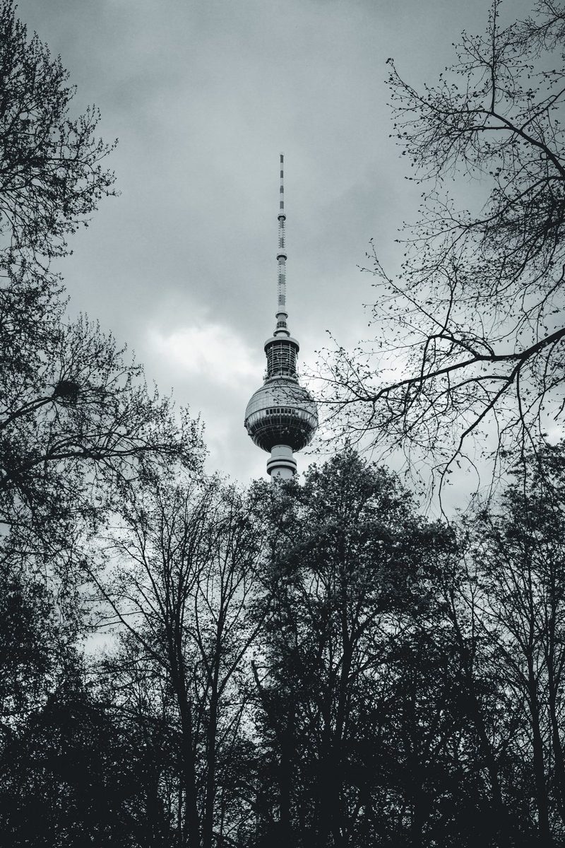 The Alexanderplatz TV Tower framed by trees that are still bare.