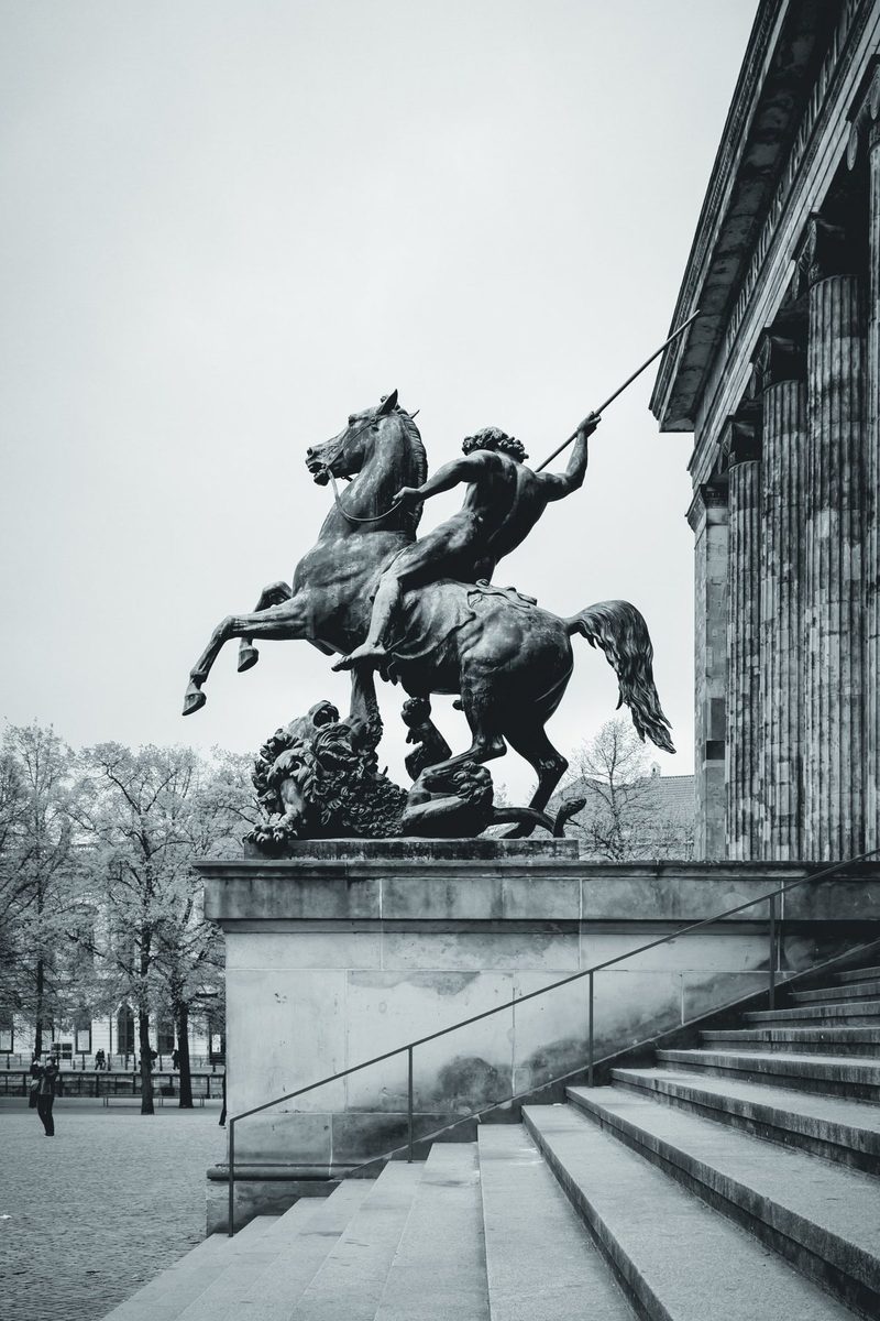 The spear-wielding rider of the Altes Museum, in mid-leap above the steps.